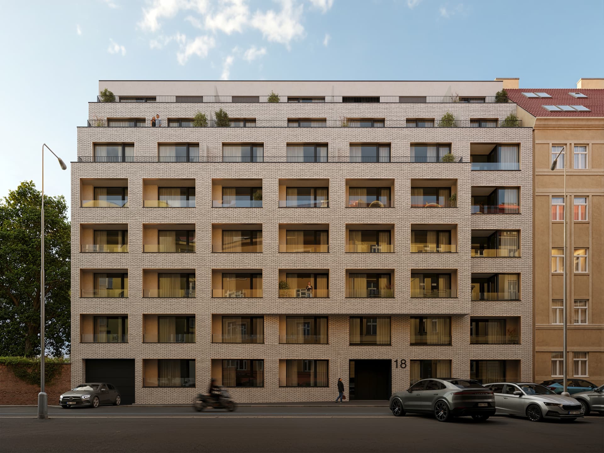 Uliční fasáda domu Světova 18 s vchodem a terasami na střeše za dne